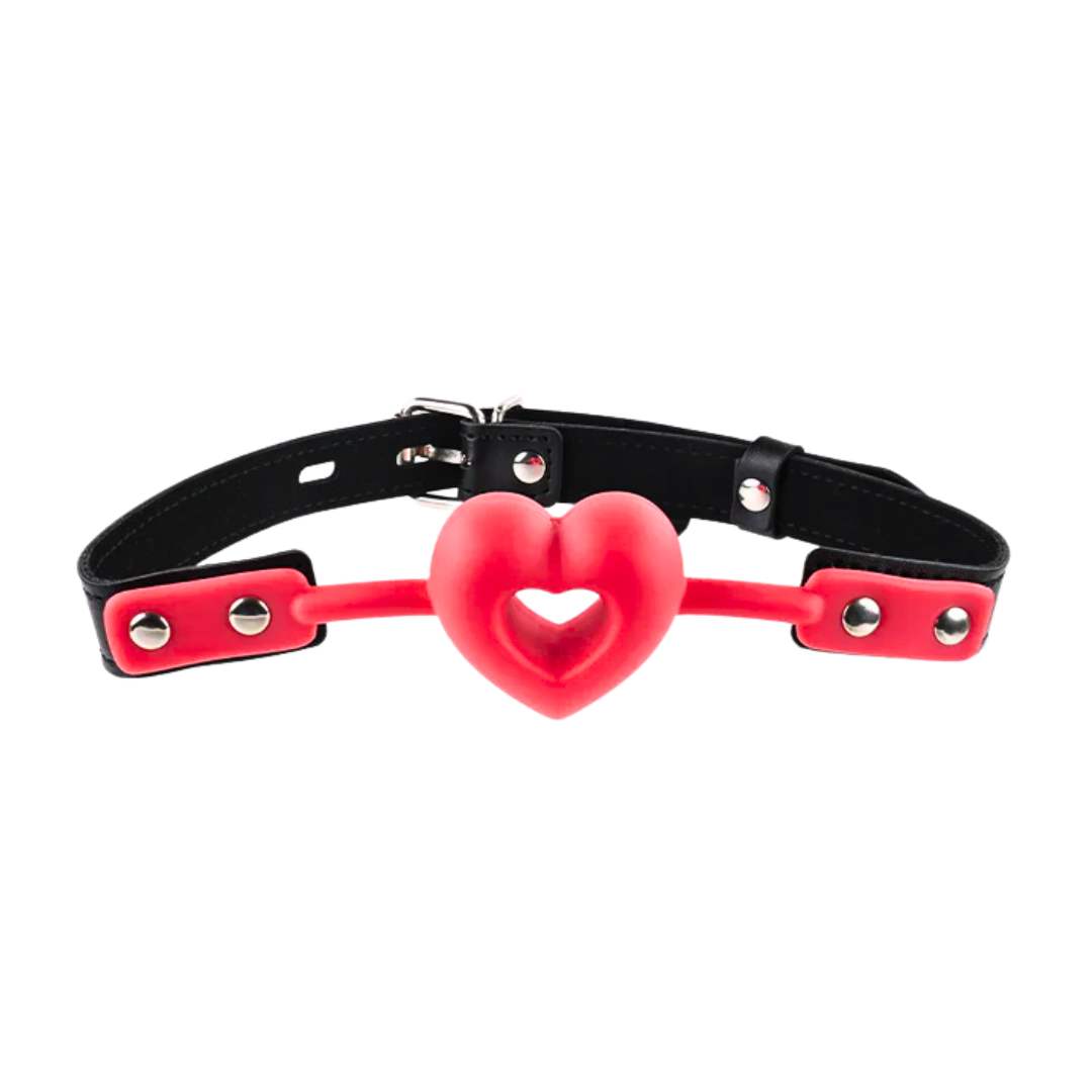 Sex and Mischief Amor Ball Gag with a heart-shaped breathable design, adjustable buckle strap, and durable PU leather and silicone materials.
Amor Ball Gag, heart-shaped ball gag, breathable ball gag, beginner BDSM gag, adjustable BDSM gag, PU leather gag, romantic ball gag, BDSM accessories, silicone ball gag, playful bondage gear.