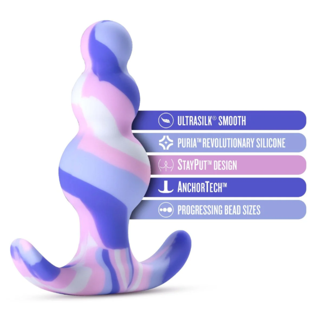 The Avant Twilight Butt Plug highlighted with key features, including Ultrasilk® smooth finish, Puria™ silicone, StayPut™ design, AnchorTech™ base, and progressing bead sizes.