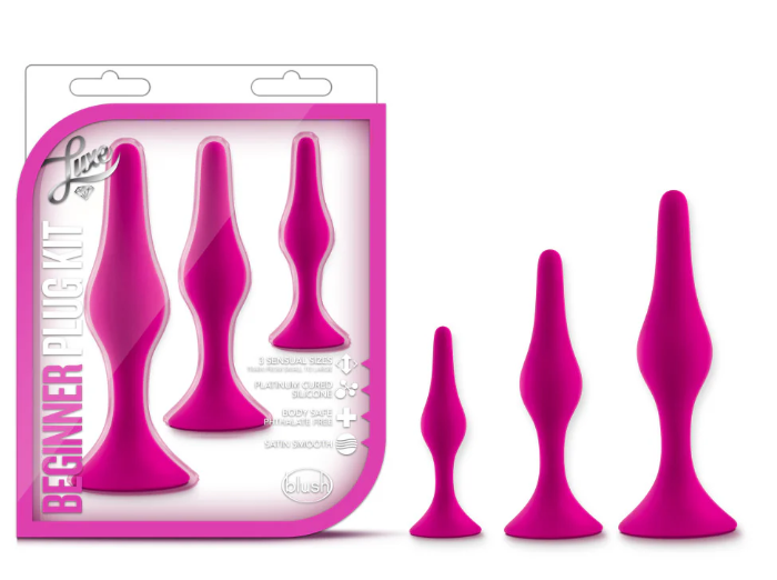 Luxe Beginner Plug Kit in Pink: Satin-smooth silicone, body-safe design, and three graduated sizes make this perfect for anal play beginners. Features tapered tips, suction cup bases, and easy-clean material.