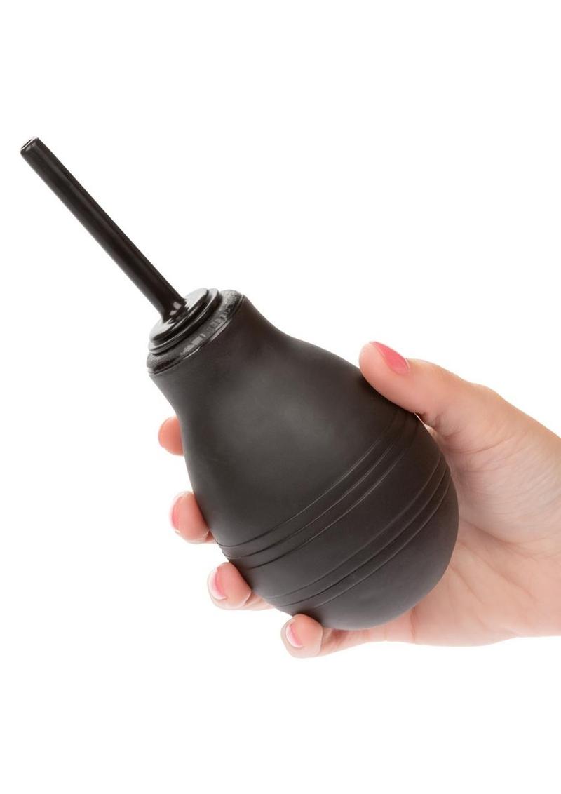One-Way Anal Douche by CalExotics featuring a sleek black bulb and nozzle design. The packaging highlights its easy-to-use nature, one-way flow design to prevent backflow, 7.3 fl. oz. capacity, and 1-year warranty.