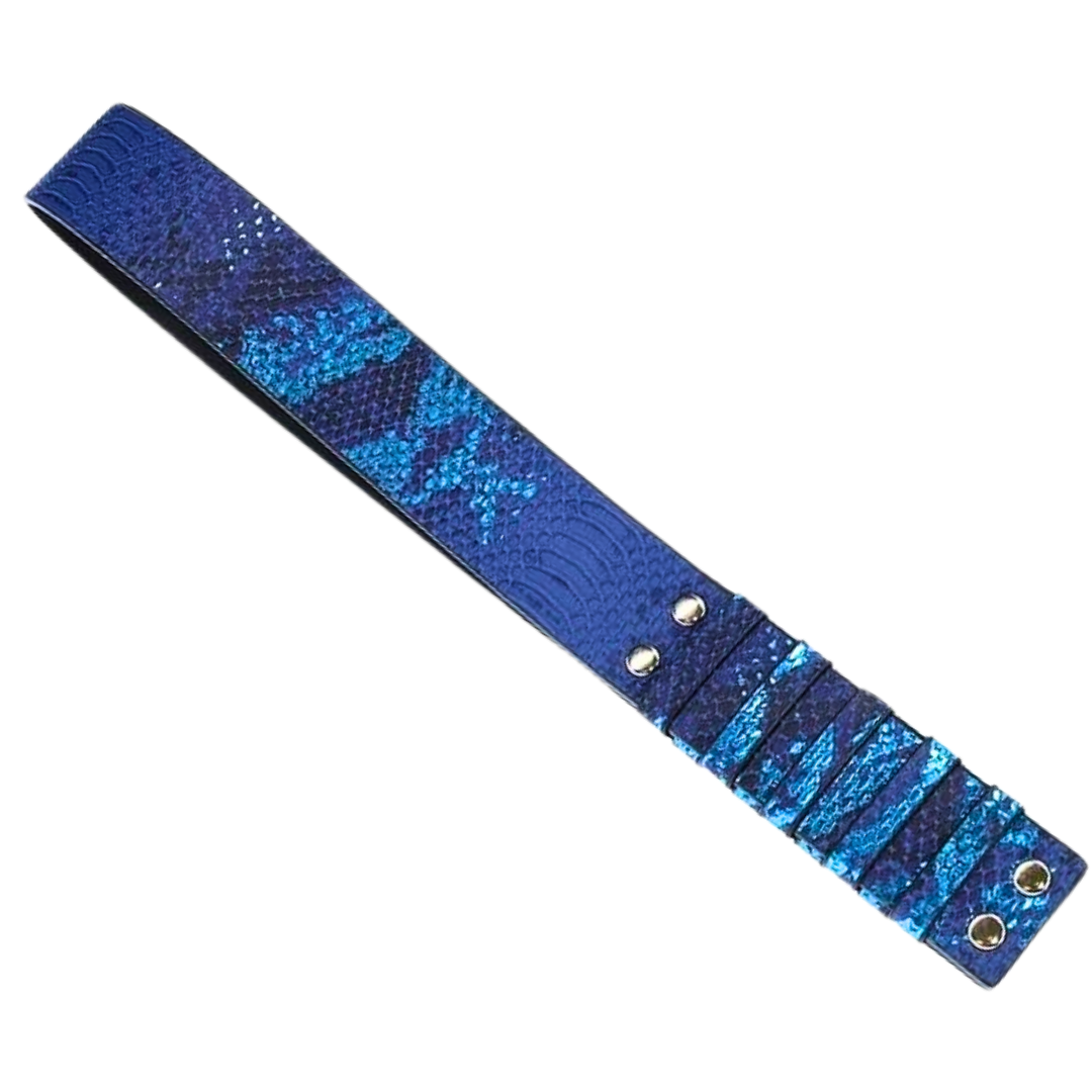 Textured bonded leather paddle with gold-tone accents, available in blue, black, and white, designed for stylish BDSM play.
