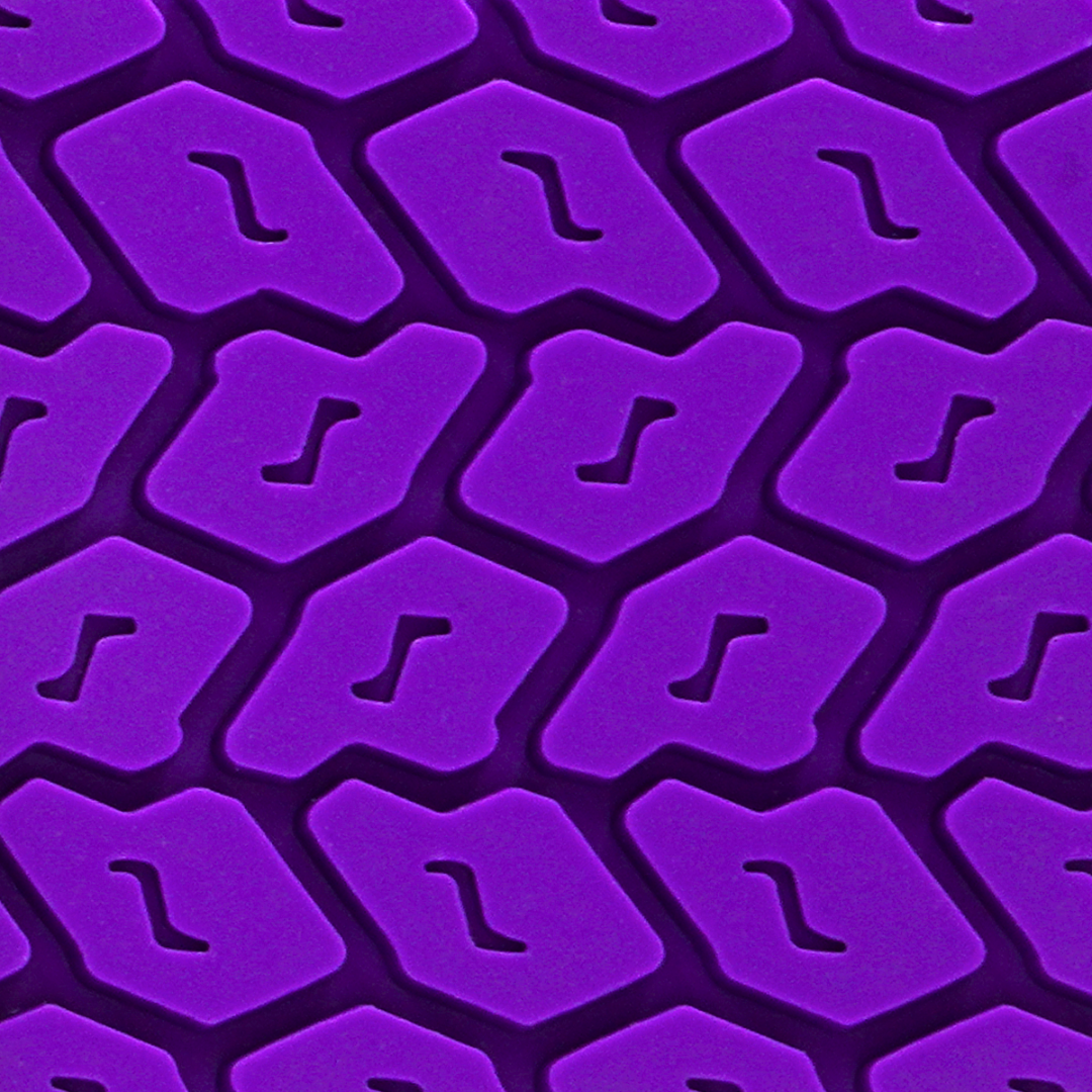 Double-sided spanking paddle with sleek smooth and tyre-textured surfaces, available in Black, Purple, and Red, featuring vegan materials and stylish design.