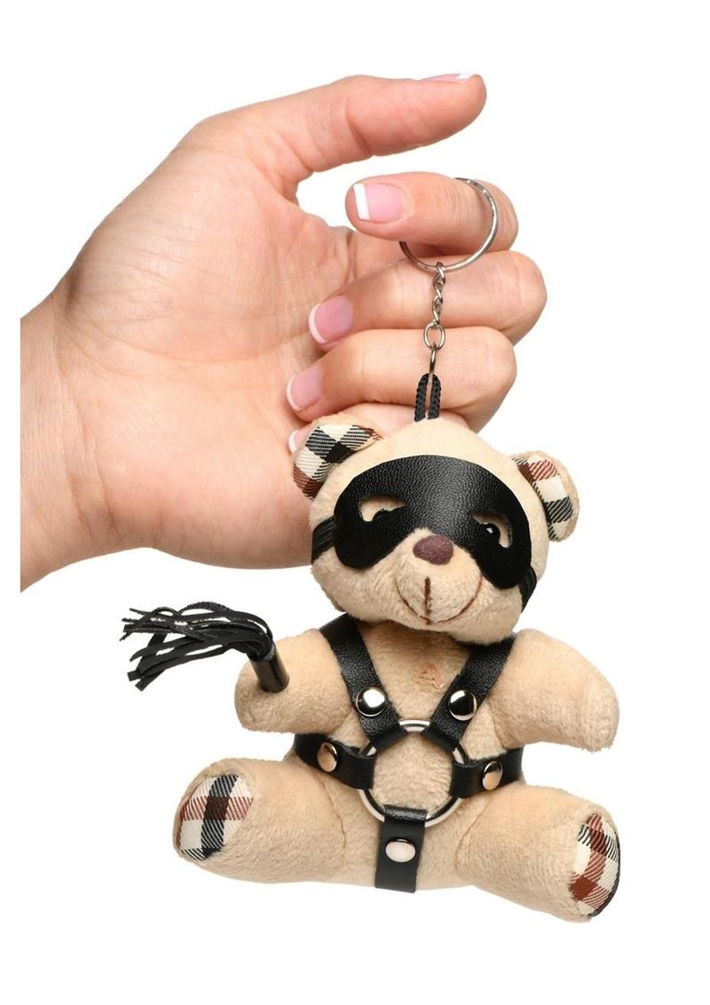 Mini bondage bear with harness, flogger, and removable eye mask for kinky gifting or accessories.
bondage bear keychain, BDSM novelty gift, bondage bear accessory, kinky keychain gift, leather harness bear, mini BDSM bear, bondage-themed gifts, faux leather keychain bear, bondage novelty toys, BDSM flagging accessory
