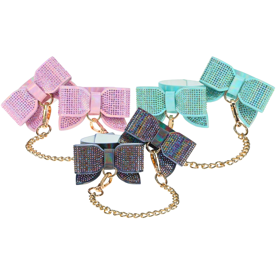 Adjustable handcuffs with rhinestone bows and a gold chain leash, available in black, pink, and blue for stylish and playful BDSM use.