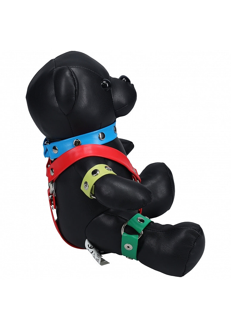 Black BDSM teddy bear with a vibrant rainbow harness featuring red, blue, green, yellow, and purple accents—cheeky, bold, and playful.

