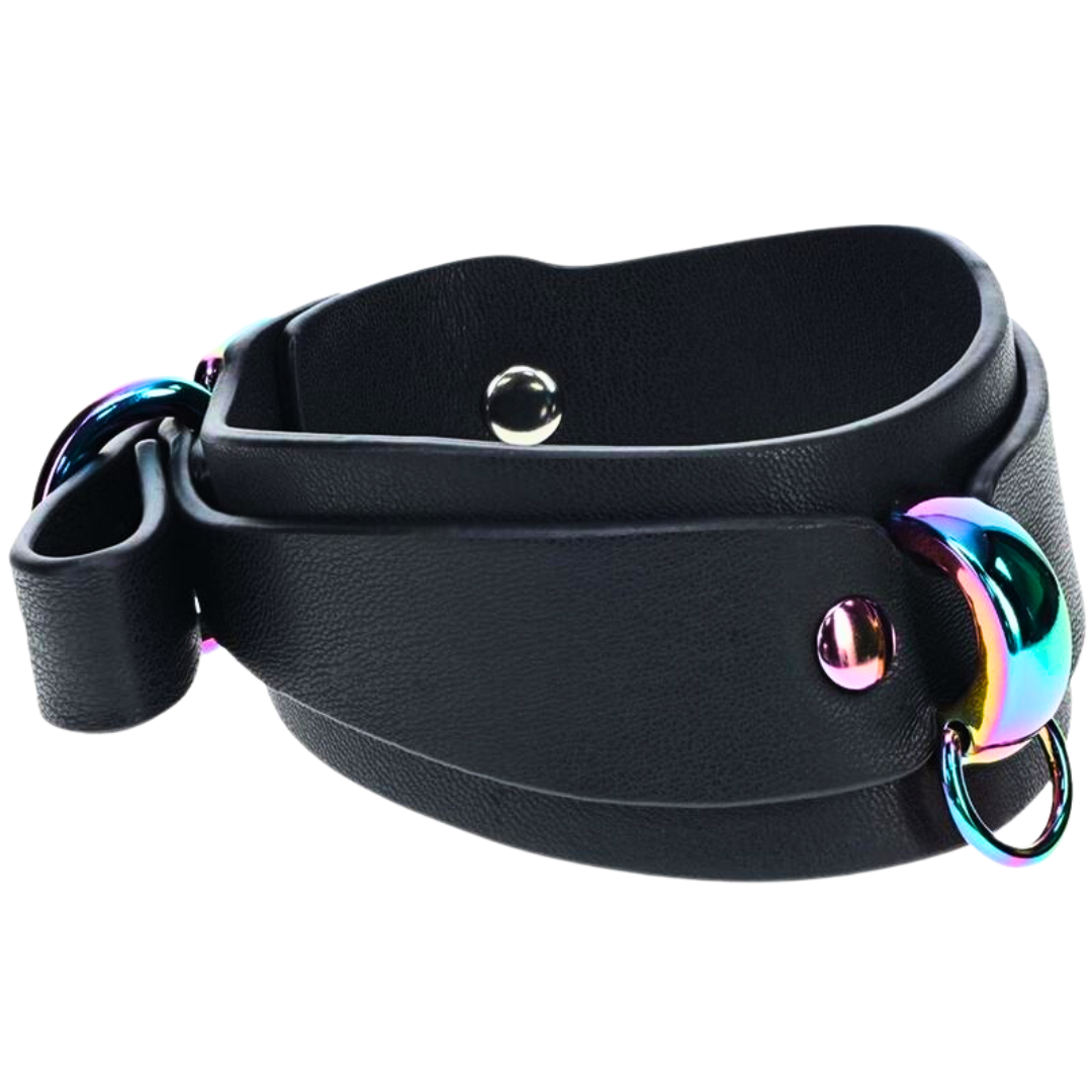 Black bonded leather ankle cuffs with iridescent rainbow hardware and a rainbow chain, designed for stylish BDSM restraint.