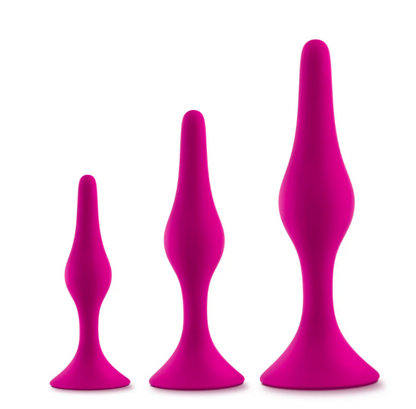 Luxe Beginner Plug Kit in Pink: Satin-smooth silicone, body-safe design, and three graduated sizes make this perfect for anal play beginners. Features tapered tips, suction cup bases, and easy-clean material.