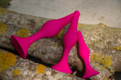 Luxe Beginner Plug Kit in Pink: Satin-smooth silicone, body-safe design, and three graduated sizes make this perfect for anal play beginners. Features tapered tips, suction cup bases, and easy-clean material.