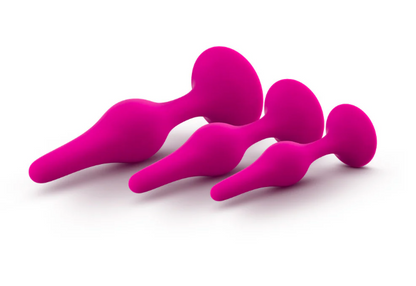 Luxe Beginner Plug Kit in Pink: Satin-smooth silicone, body-safe design, and three graduated sizes make this perfect for anal play beginners. Features tapered tips, suction cup bases, and easy-clean material.