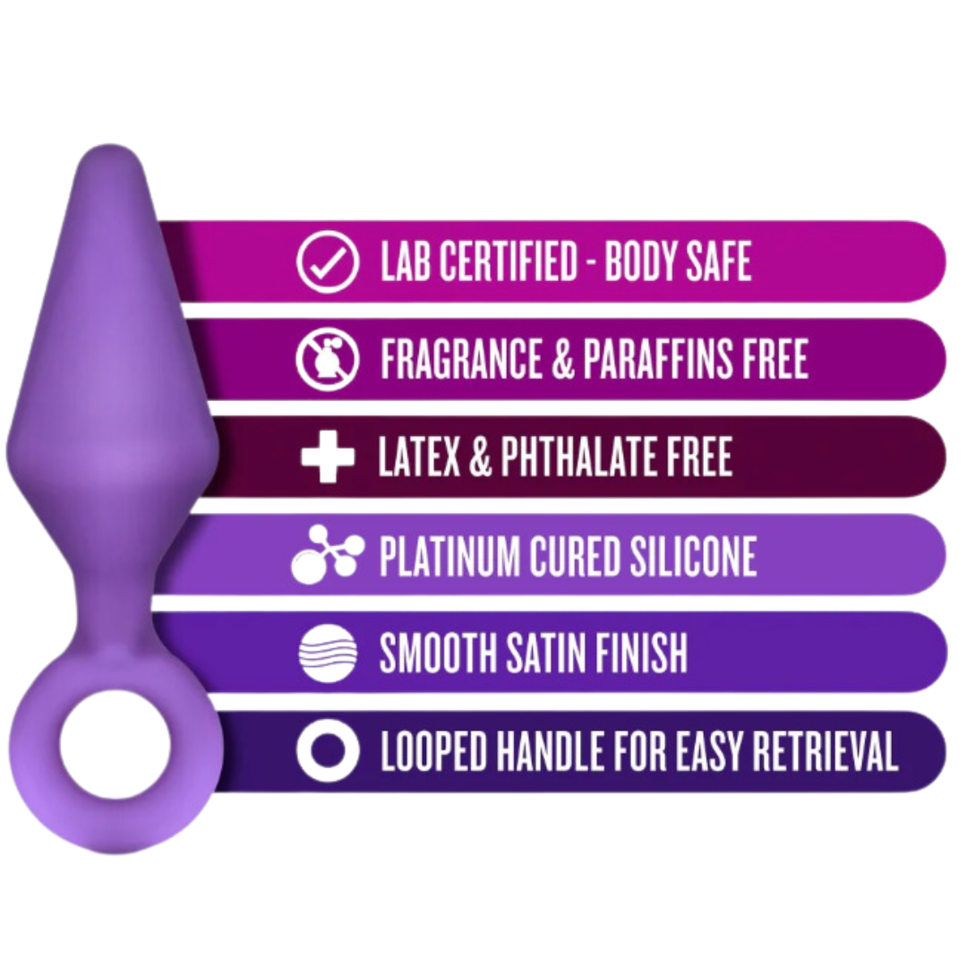 A purple Candy Rimmer Small Butt Plug with labeled features, including lab-certified body-safe material, platinum-cured silicone, smooth satin finish, and a looped handle for effortless handling.