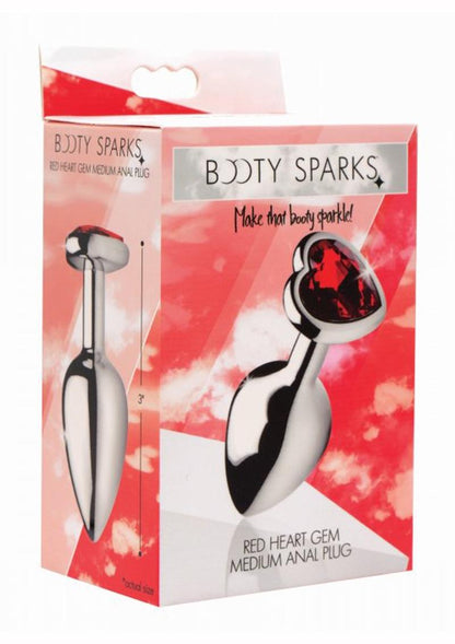 Packaging of the Booty Sparks Red Heart Gem medium Anal Plug, showcasing its sleek, metal finish and heart-shaped crimson gem. Tagline: "Make that booty sparkle!" Highlights include a smooth, nickel-free aluminum alloy design.