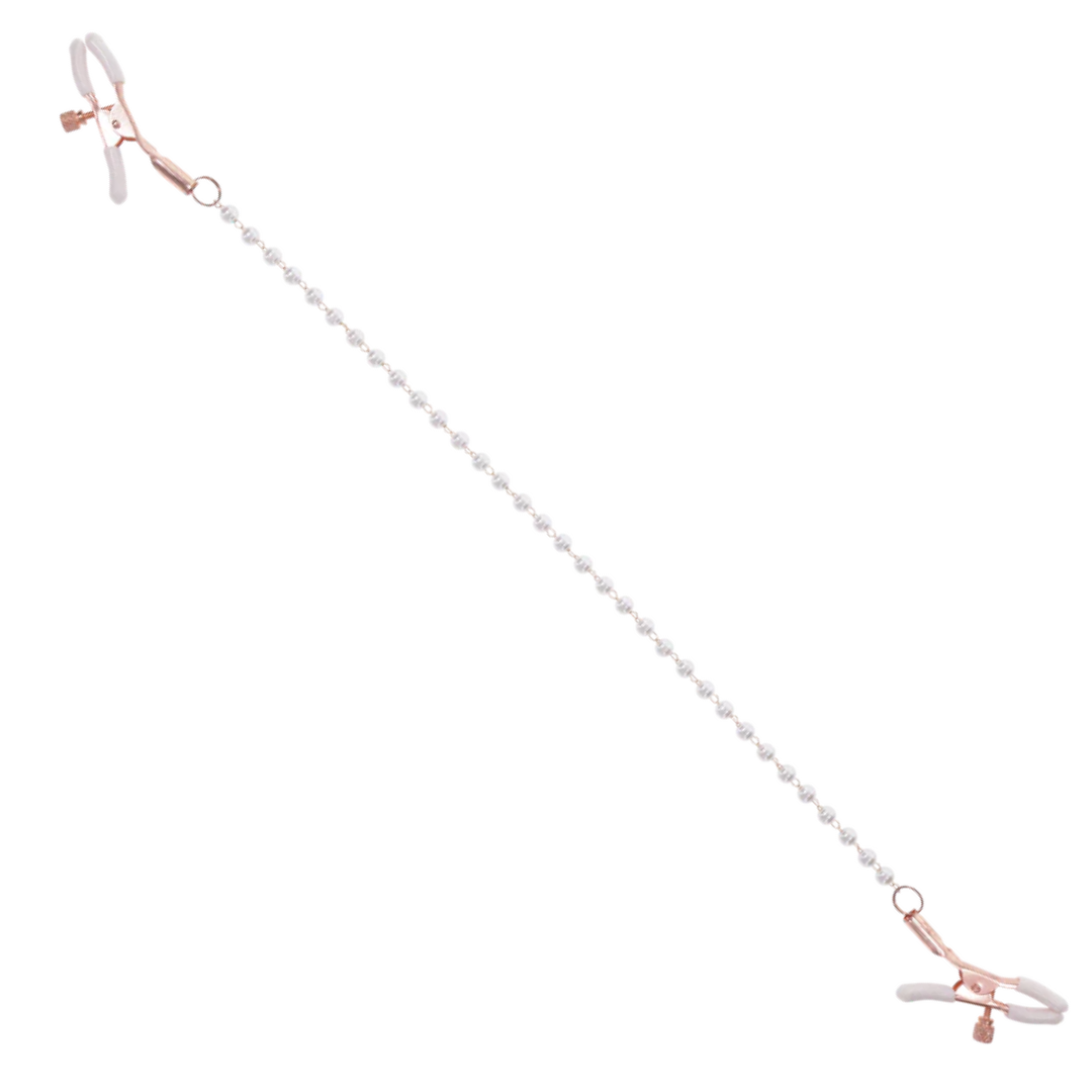Rose gold nipple clamps with faux pearl accents. Adjustable design with white rubber tips to enhance sensitivity. Hypoallergenic and nickel-free for safe, stylish play.