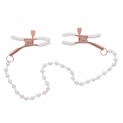 Rose gold nipple clamps with faux pearl accents. Adjustable design with white rubber tips to enhance sensitivity. Hypoallergenic and nickel-free for safe, stylish play.