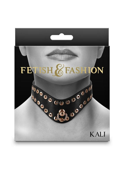 Black BDSM collar with gold-tone studs, adjustable buckle, and D-ring for leash attachment. Keywords: BDSM collar, gold studded collar, adjustable fetish collar, PU leather BDSM collar, vegan BDSM collar, nickel-free collar, BDSM accessories, luxury BDSM gear, Kali collar, black and gold BDSM collar.