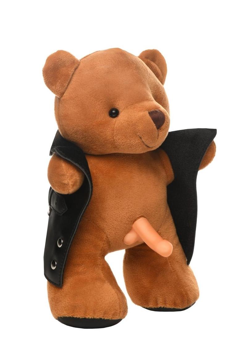 Brown plush teddy bear wearing a black vegan leather jacket, holding it open to reveal a light-colored dong and a cheeky grin.

