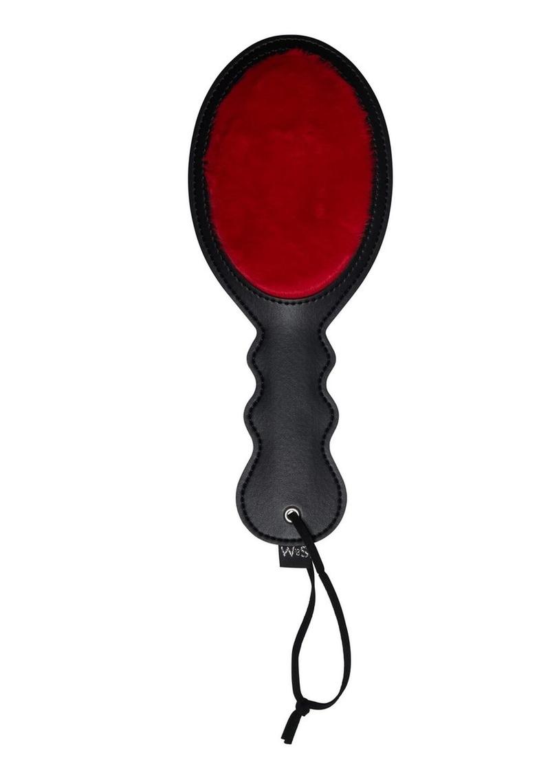 Sex and Mischief Amor Paddle - Black/Red. Sportsheets Amor Paddle with a dual-sided design, featuring red faux fur on one side and smooth faux leather on the other, ideal for BDSM play.

