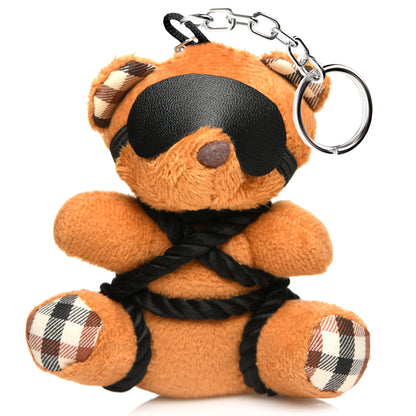 Burnt orange teddy bear keychain tied in silky rope bondage with a removable blindfold, a fun novelty accessory or gift.

shibari teddy bear keychain, rope bondage bear keychain, BDSM novelty gift, bondage bear keychain accessory, kinky teddy bear gift, burnt orange bear keychain, shibari rope bear, playful bondage bear keychain, BDSM-themed keychain gift, novelty shibari bear accessory